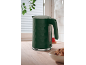 Dark green kettle with a hexagonal pattern on a wooden kitchen counter.