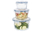Stack of glass food storage containers with blue lids, filled with zucchini and bulgur.