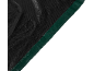 Detail of a black garden tarp with a green border.