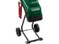 Green garden shredder with a red pusher and wheels.