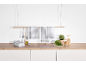 Black and white checkered kitchen towels hanging on a wooden bar above a kitchen counter.