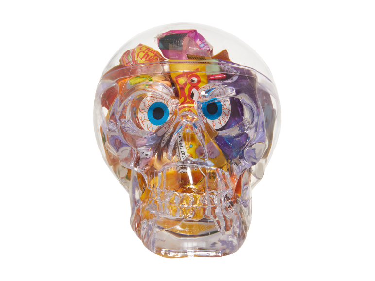 Clear skull filled with colorful candies and lollipops, featuring large eye decorations.