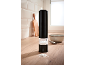 Black electric salt grinder on a kitchen counter with spilled salt.