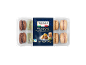 Packaged macarons with chocolate, pistachio, lemon, and caramel flavors.