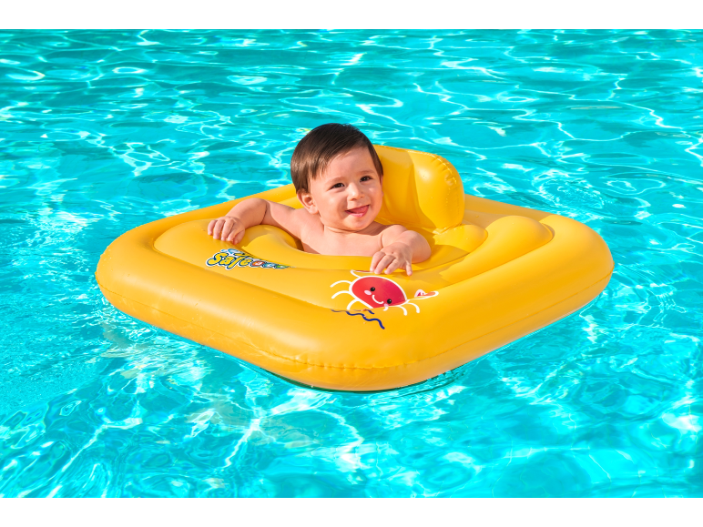 Smiling baby in a yellow pool float with a red crab.