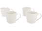 Four white ceramic mugs on a black background.