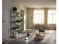 Shelving unit with tools, hand truck, and ladder in a room under renovation.