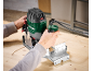 Man using a router to work on a wooden board.