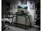 Black gaming desk with green accents, monitor, office chair, and shelving units.