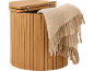 Wooden storage basket with a lid and a beige blanket draped over the edge.