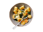 Gnocchi with spinach and Parmesan cheese in a bowl, one cut open showing the filling.