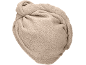 Beige terry towel rolled up.