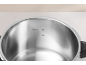Inside of a stainless steel pressure cooker with fill level markings