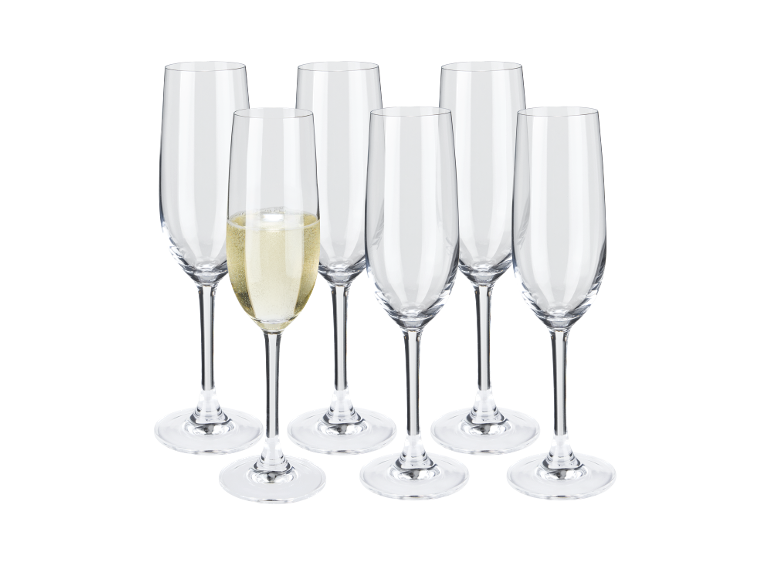 Six champagne flutes, one filled with champagne, on a black background.
