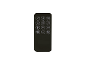 Black remote control with white icons and buttons on a black background