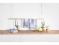 White and blue checkered kitchen towels hanging in a modern kitchen with a wooden countertop.