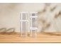 Clear stackable storage containers with white lids on a wooden table.
