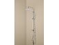 Chrome shower set with a fixed shower head and a handheld shower on a beige wall.