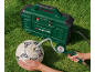 Green air compressor inflating a football on grass.