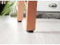 Wooden furniture legs with felt pads on a light wood floor.