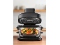 Black air fryer with an open lid and a bowl full of chopped vegetables.