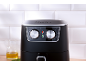 Black air fryer with two silver dials for temperature and timer settings.