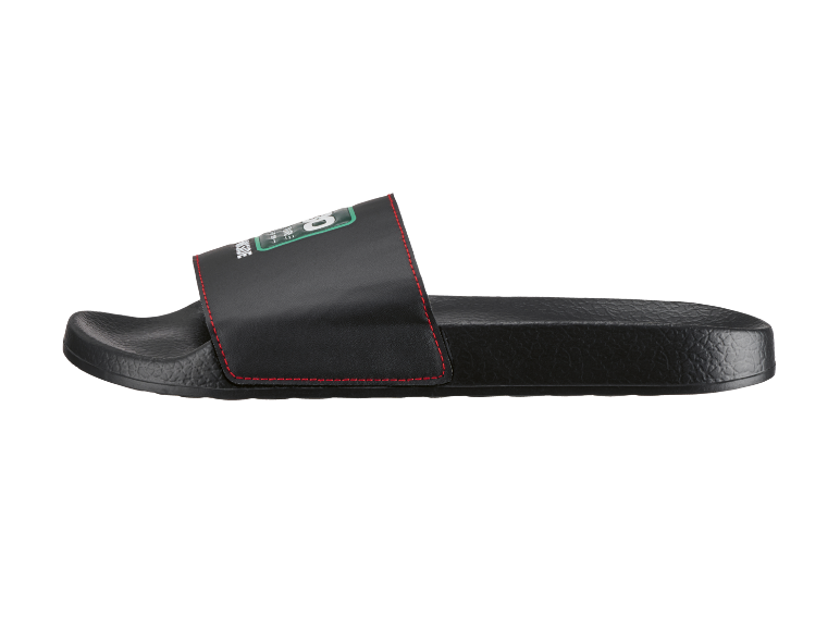 Black slide sandals with red stitching and green text on the strap.