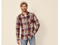Man in plaid flannel shirt, white t-shirt, and jeans with a beanie.