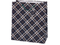 Gift bag with navy, white, and orange plaid pattern with green handles.