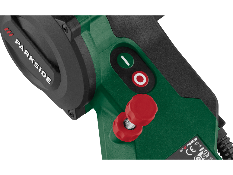 Close-up of a green power tool with red and green buttons and a red knob.