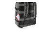 Grey backpack with a red and white document sticking out of a side pocket