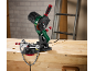 Chainsaw sharpener on a wooden workbench with a chainsaw chain attached.