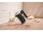 Hand mixer with whisk and dough hooks, milk, flour, and eggs on a wooden counter.