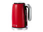 Red electric kettle with chrome accents, water level indicator, and '1973' inscription.