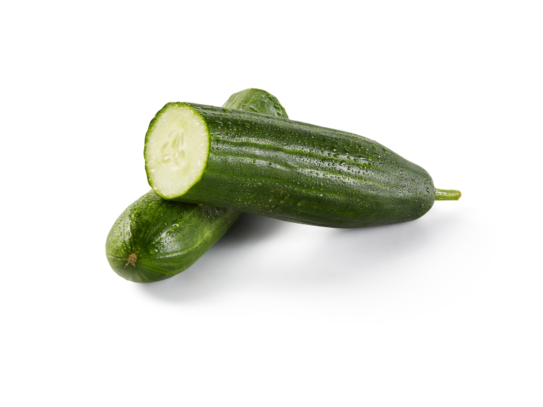 Two fresh green cucumbers with water droplets, one cut in half, on a white background.