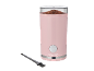 Pink coffee grinder with ground coffee and a cleaning brush.