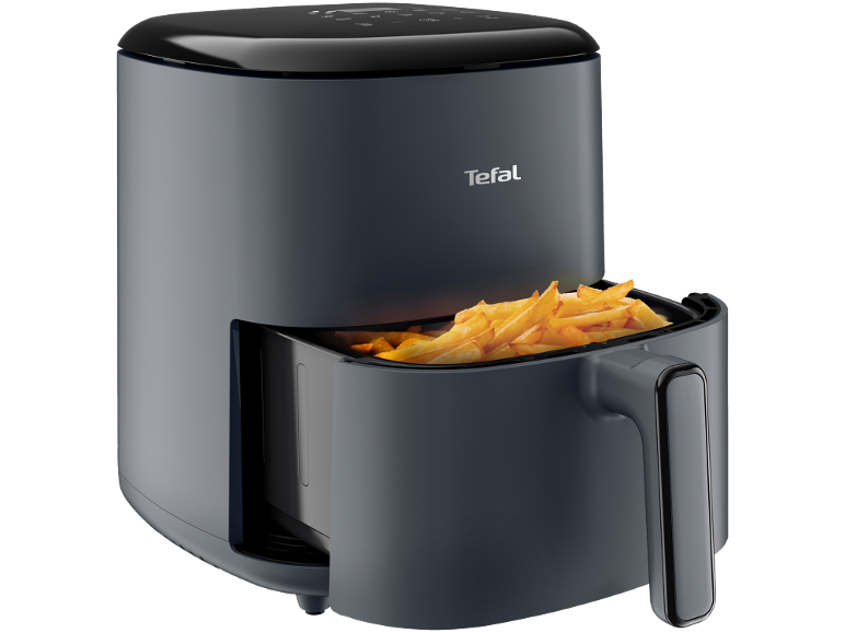 Dark grey air fryer with a basket full of golden french fries.