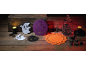 Halloween decorations with ghosts, pumpkins, owls, and candles on a wooden table.