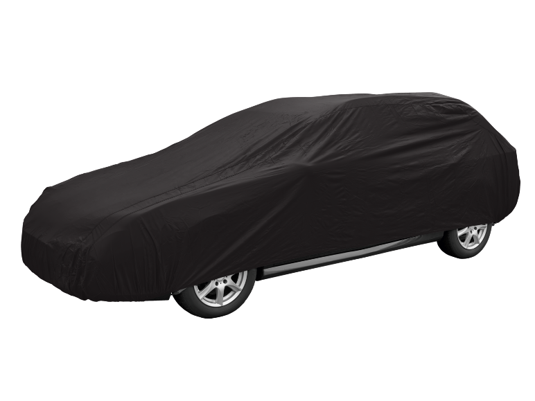 Car covered with a black protective cover on a black background