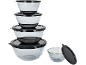 Set of stacked glass bowls with black lids, and one separate bowl.
