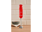 Red immersion blender with '1973' inscription on a wooden countertop with a bowl.