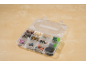 Organizer box with rotary tool accessories, such as sanding discs and brushes.