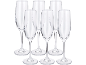 Six clear champagne flutes on a black background.