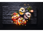 Ice cream desserts with fruit, festive decorations, and fairy lights on a dark slate background.