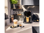 Coffee machine with a touchscreen display, preparing latte and espresso, in a modern kitchen.