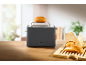 Toaster with a bun on the rack and fresh buns on a wooden board.