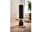 Electric pepper grinder on a kitchen countertop with garlic and peppercorns.