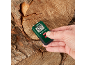 Hand holding a wood moisture meter displaying 20.0% on a cut log.