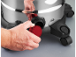 Man's hand opening a red cap at the bottom of a wet/dry vacuum cleaner.