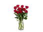 A bouquet of fresh red roses in a glass vase.